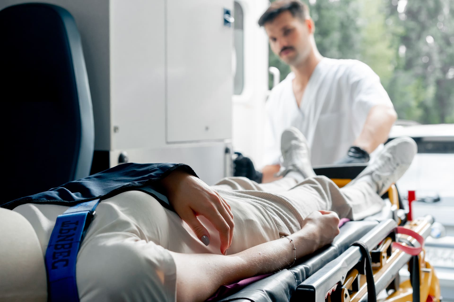Paramedic attending to an injured patient in an ambulanc